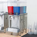 A Crathco refrigerated beverage dispenser with two blue and red containers.