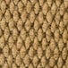 A close up of a brown jute carpet with white threads.