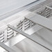 A close-up of a stainless steel Avantco refrigeration pan divider bar.