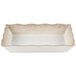 A white rectangular melamine tray with a scalloped tan border.