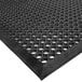 A black rubber Cactus Mat with circular holes.