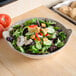 A Thunder Group Jazz melamine bowl filled with salad on a table.