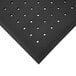 A black Cactus Mat anti-fatigue floor mat with holes.