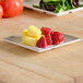 A Thunder Group Jazz melamine plate with fruit on a table.