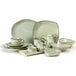 A set of Tuxton China trays in green with gold accents on a white background.