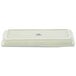 A white rectangular Tuxton china tray with a blue and white box.