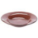A close-up of a brown Tuxton china soup bowl with a rim.