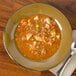 A Tuxton Mojave rim china soup bowl filled with soup and vegetables.