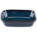 A blue rectangular Tuxton China side dish with a black rim.