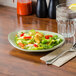 A Tuxton Artisan Sagebrush china plate with a salad on it.
