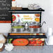 A Hatco countertop soup warmer with two wells on a counter with a sign.