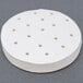 A white circular object with holes in it.