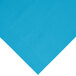 A turquoise blue plastic table cover on a white surface.