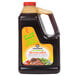 A black plastic container of Kikkoman Less Sodium Teriyaki Marinade and Sauce with a yellow label.