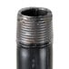 A close-up of a black Cooking Performance Group gas manifold pipe with a metal cap on top.