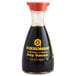 A Kikkoman Traditionally Brewed Soy Sauce bottle on a counter.