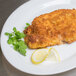 A plate of fried chicken coated in Kikkoman Panko bread crumbs with lemon wedges and parsley.