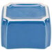 A blue and white ceramic cube with a square dish on top.