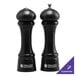 A black Chef Specialties Windsor pepper mill and salt shaker set with a silver top.