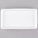 A white rectangular Tuxton AlumaTux ramekin tray.