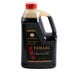 A plastic container of Kikkoman Tamari soy sauce.