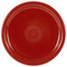 A close-up of a Fiesta® Healthcare China plate in red with a circular design in the middle.