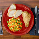 A Scarlet Fiesta Healthcare china plate with food on it.