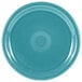 A turquoise plate with a circular pattern.