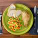 A piece of bread on a green Fiesta healthcare plate.