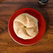 A Scarlet Fiesta bread and butter plate with a piece of bread on it.