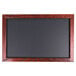 A mahogany framed black chalkboard.