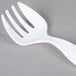 A white plastic Fineline Serving Fork.