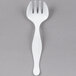 A white plastic Fineline Serving Fork.