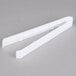 A pair of Fineline white plastic serving tongs.