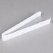 A pair of white Fineline plastic serving tongs.