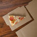 A slice of pizza on a GreenBox pizza box.