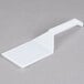 A white Fineline plastic spatula on a gray surface.