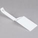 A Fineline white disposable spatula with a corner.