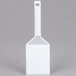 A white plastic spatula with a white handle.
