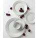 A close-up of a Tuxton Pacifica bright white embossed china plate with cherries on it.