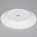 A Tuxton bright white china plate with an embossed rim.