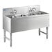 A stainless steel Advance Tabco underbar sink with 4 compartments and faucets.