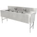 A stainless steel Advance Tabco underbar sink with four compartments and two drainboards on a counter.