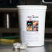A white bucket of Alto-Shaam cleaning tabs on a counter.