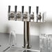 A Beverage-Air stainless steel beer tower with 5 taps on a counter.