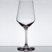 A close-up of a Stolzle Revolution all-purpose wine glass on a table with a white background.