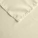 A close up of an ivory rectangular Intedge cloth table cover.