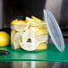 A Carlisle clear plastic crock filled with lemons.