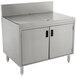A stainless steel Advance Tabco drainboard cabinet with doors over a sink.