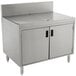 A stainless steel Advance Tabco drainboard cabinet with doors over a sink.